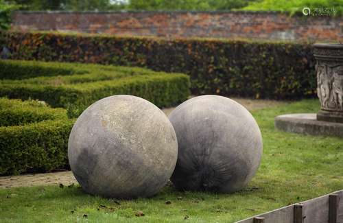 A pair of large limestone ornamental spheres