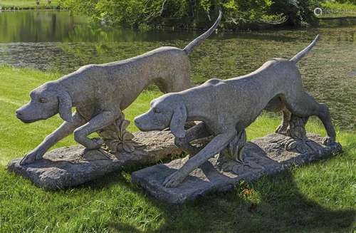 A pair of carved limestone models of hounds