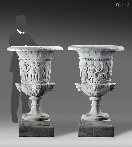 A pair of large Continental sculpted white marble urns