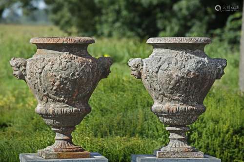 A pair of Continental cast iron garden urns