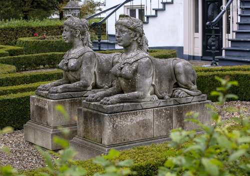 A pair of substantial sculpted limestone models of recumbent...