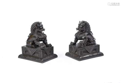 A pair of Chinese bronze Buddhist lions and stands
