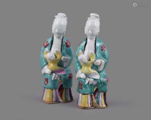 A pair of Chinese porcelain Famille Rose models of seated la...