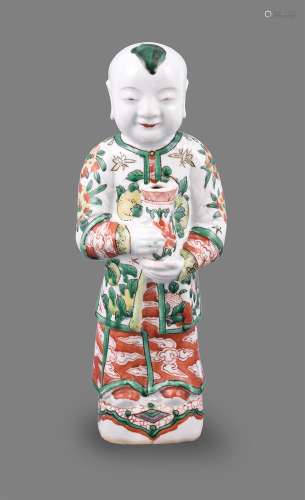 A good Chinese porcelain wucai standing figure of a boy hold...