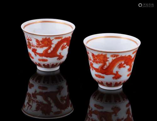 A pair of Chinese iron red 'Dragon and phoenix' wine cups