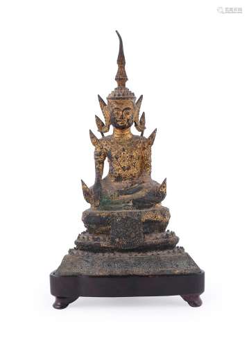 A Thai bronze figure of Budhha seated on a high pedestal thr...