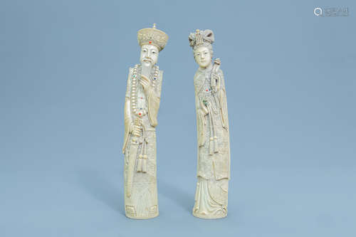 A pair of Chinese inlaid carved ivory figures of the emperor...