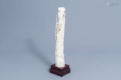 A large Chinese carved ivory figure of a lady on a wooden ba...