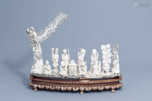 A large Chinese carved ivory 'Eight Immortals' group on a wo...