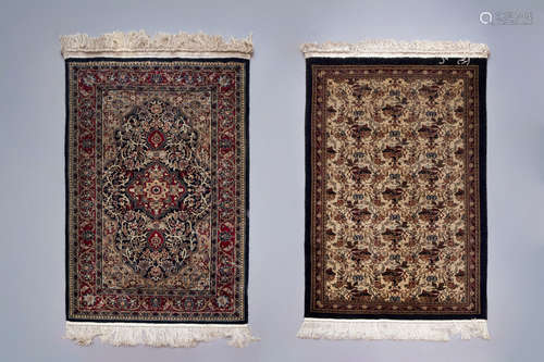 Two Oriental rugs with floral design, silk on cotton, 20th C...