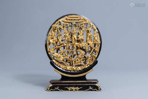 A Chinese reticulated gilt wood 'battle scene' medallion on ...