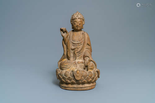 A Chinese sandstone figure of Buddha with traces of polychro...