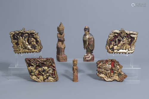 Four lacquered and gilt wood panels and three figures, China...