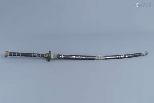 A large sword with scabbard in black lacquered wood with mot...