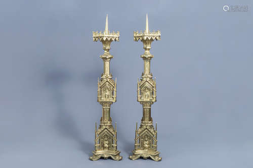 A pair of imposing French Gothic revival gilt brass candlest...