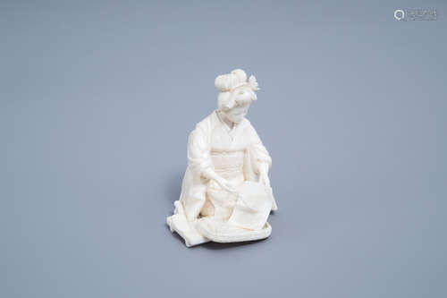 A signed Japanese ivory ikomono of a lady at work, Meiji, 19...