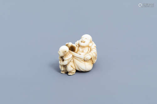 A Japanese ivory netsuke of a laughing Buddha with his serva...