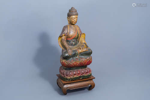 A Chinese polychrome painted wooden figure of Buddha on a lo...