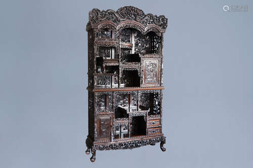 A Chinese reticulated wooden display cabinet with dragons an...