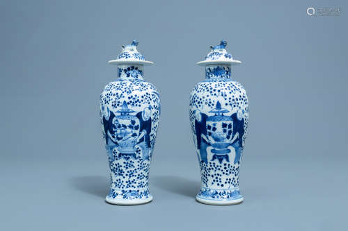 A pair of Chinese blue and white vases and covers with boys ...