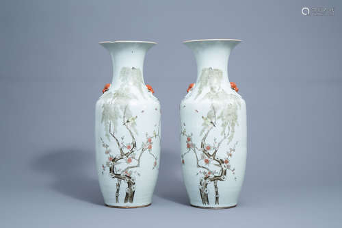 A pair of Chinese famille rose vases with birds and butterfl...