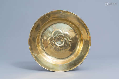 A large German brass alms dish with floral design, possibly ...