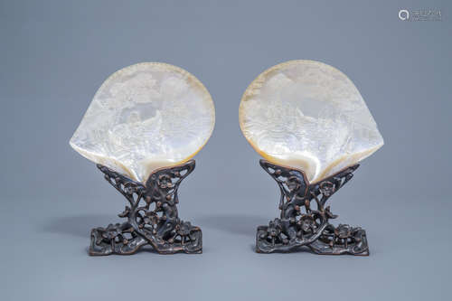 A pair of Chinese carved mother-of-pearl shells on wooden st...