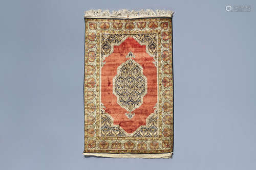 A fine Oriental rug with a central medallion and floral desi...