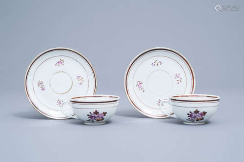 A pair of Chinese famille rose armorial cups and saucers, ca...