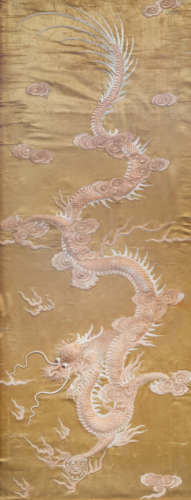 A Chinese vertical silk embroidery with a dragon chasing the...