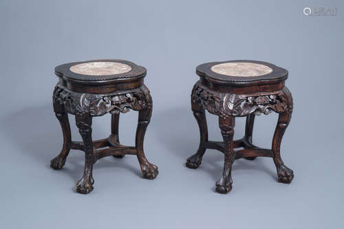 A pair of Chinese carved wooden stands with marble top, 19th...