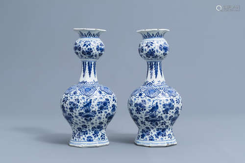 A pair of Dutch Delft blue and white vases with floral desig...