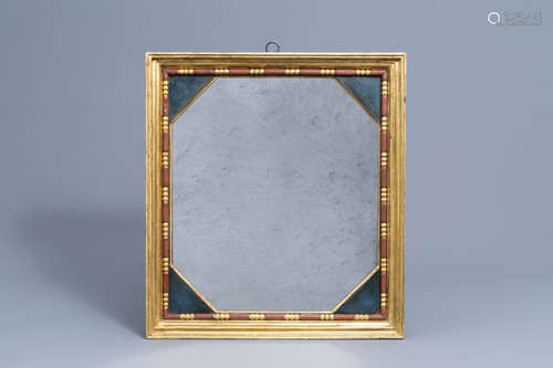 An octagonal mirror in a gilt and polychrome decorated woode...