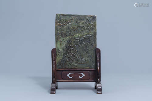 A Chinese jade 'dragons and phoenixes' plaque mounted in a w...