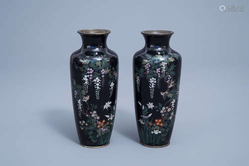 A pair of fine Japanese cloisonne vases with a bird among bl...