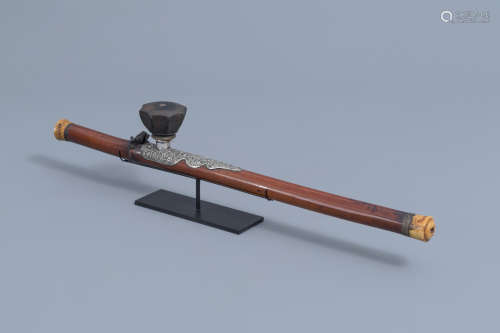 A Chinese bamboo opium pipe with a silver saddle, ivory endp...