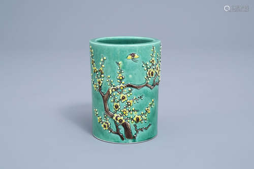 A Chinese green ground brush pot with floral relief design, ...