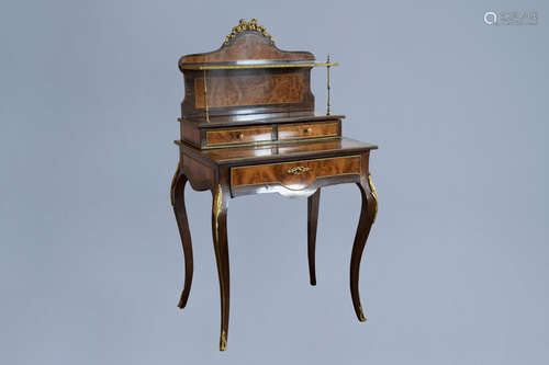 A French burl wood veneered gilt bronze mounted bonheur du j...