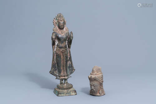 A lava stone scholar's head and a bronze figure of a Buddha,...