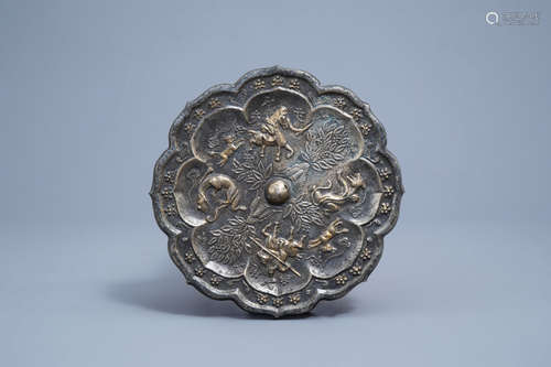 A Chinese lotus shaped gilt bronze mirror with relief design...