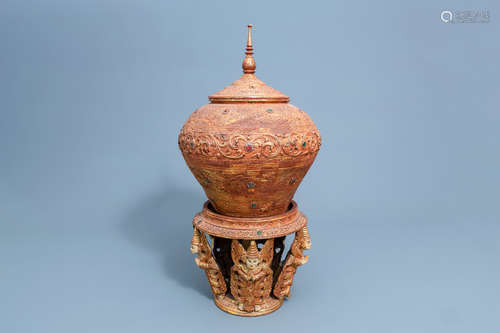 An inlaid, gilt and patinated wooden vase and cover on stand...