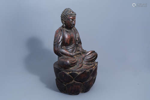 A large black and red lacquered figure of Buddha on a lotus ...