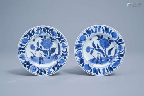 A pair of Chinese blue and white saucers with a boy in a lan...