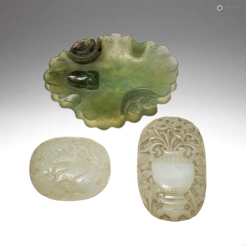 TWO PALE GREEN JADE RUYI PLAQUES AND A SERPENTINE CARVED DIS...