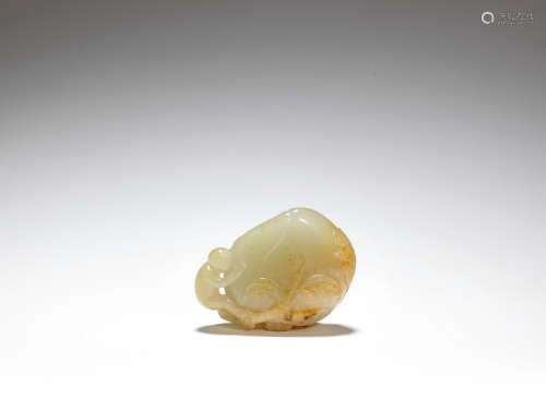 A PALE GREEN AND RUSSET JADE 'MONKEY AND PEACH' GROUP 18th c...