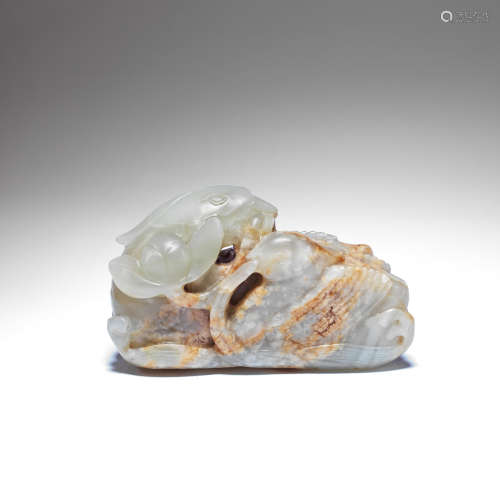 A PALE GREEN AND RUSSET JADE 'MANDARIN DUCKS' CARVING 17th/1...