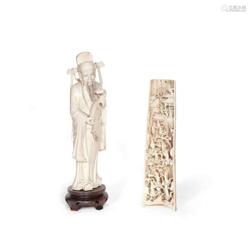 AN IVORY CARVING OF A SCHOLAR AND A CARVED IVORY WRIST REST ...