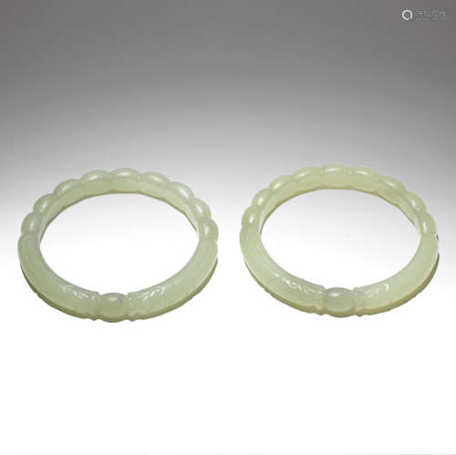 A PAIR OF PALE JADE 'CONFRONTING DRAGONS' BANGLES