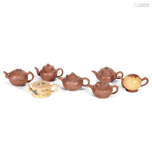 A GROUP OF SEVEN YIXING TEAPOTS AND COVERS Late Qing Dynasty...
