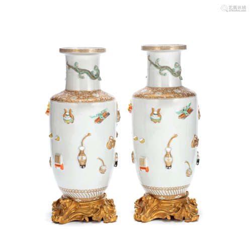 A PAIR OF MOULDED 'HUNDRED ANTIQUES' ROULEAU VASES Kangxi si...
